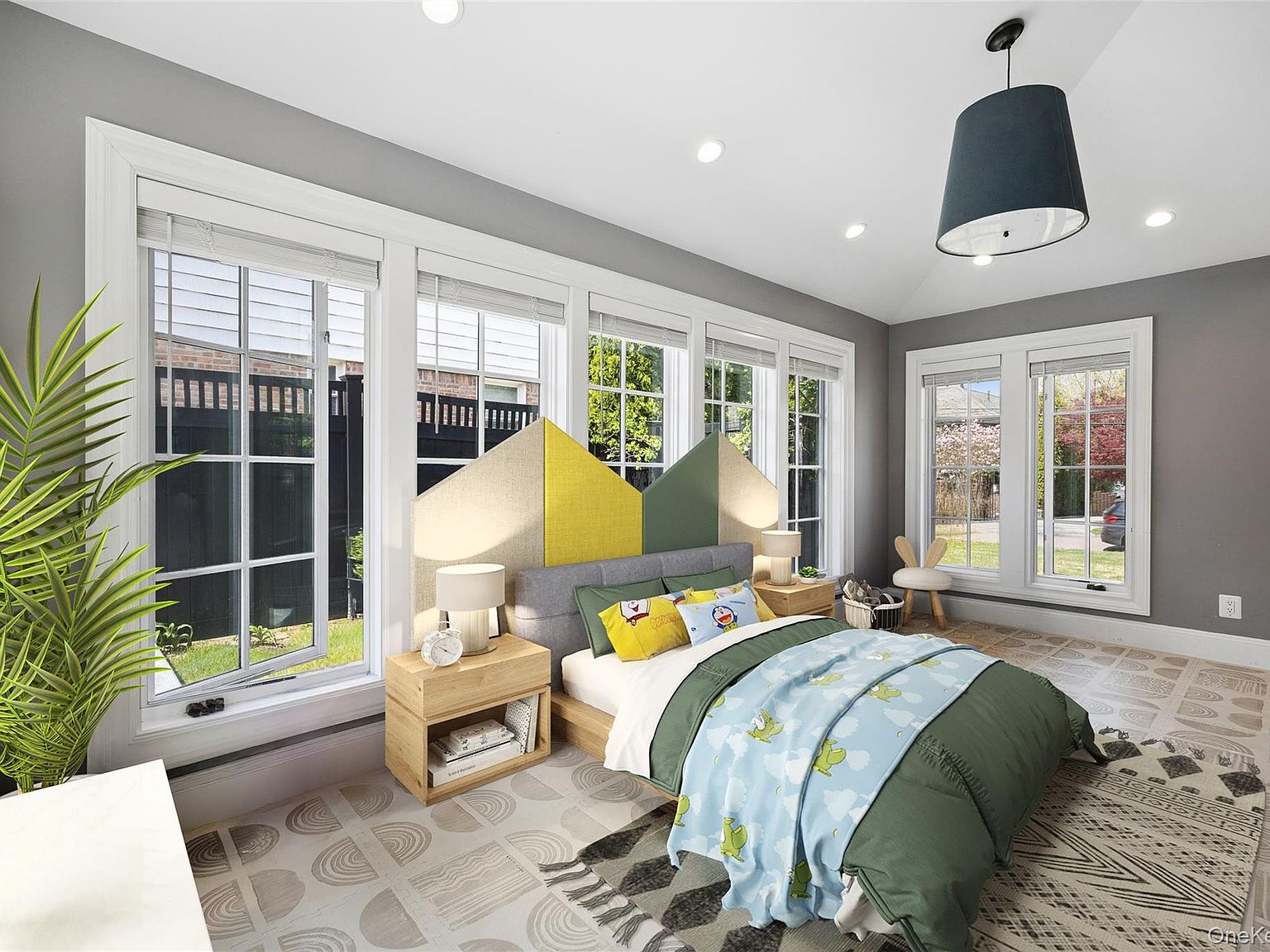 A second view of the bedroom at 216 Beverly Road, showing the wall of divided-light double-hung windows, vaulted ceiling and the garden beyond.