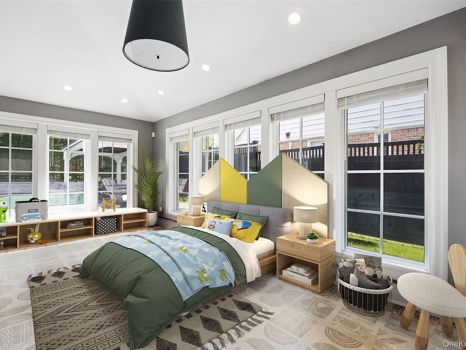 Vaulted upper bedroom at 216 Beverly Road. Wraparound divided-light windows on two walls and a peaked ceiling. The architectural signature of this landmarked 1925 Douglaston Manor Colonial.